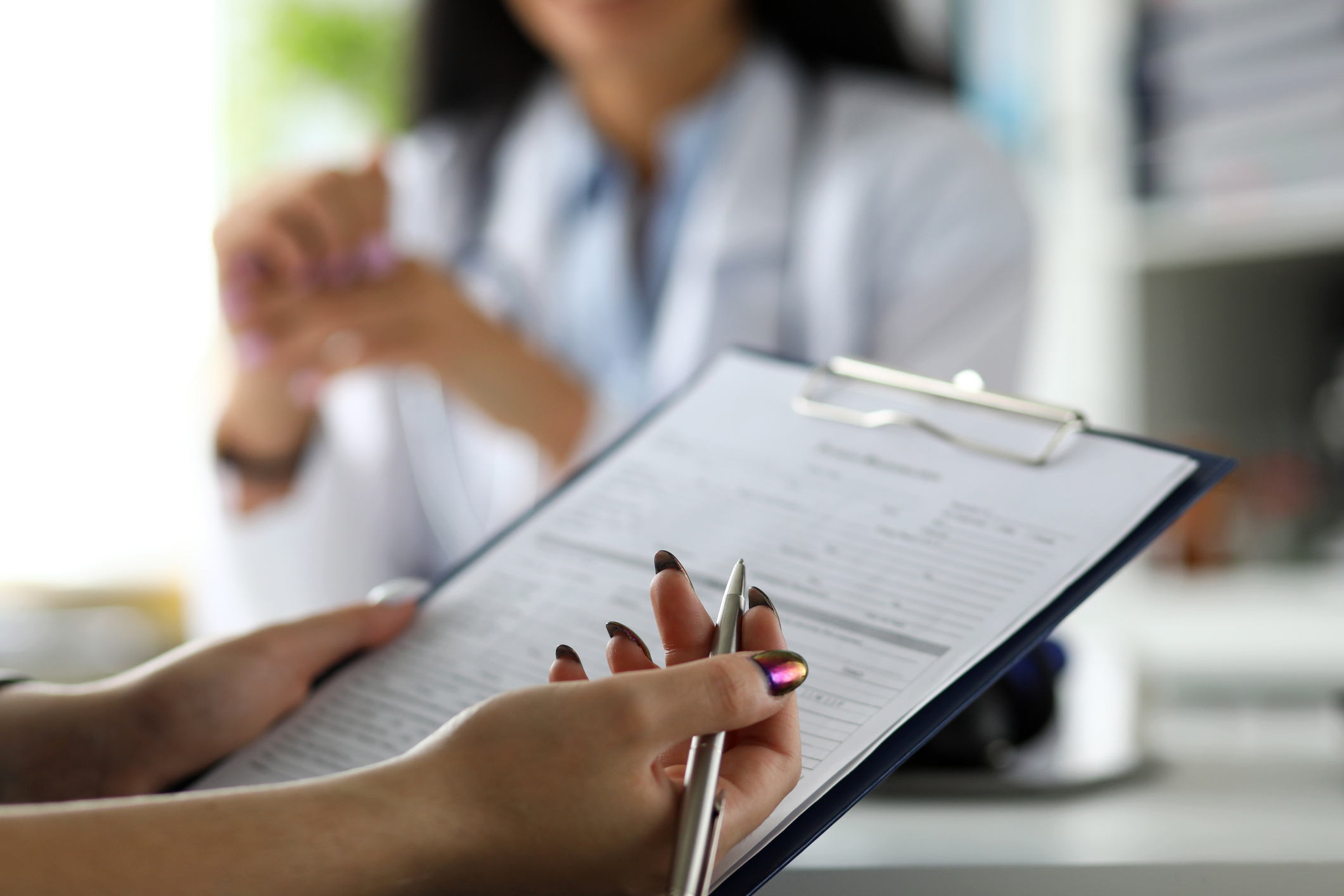 patient with iridescent nail polish completing survey