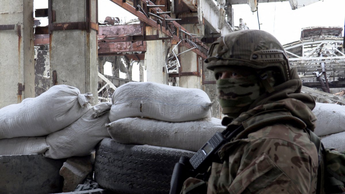 A Ukrainian serviceman stands guard in Avdiivka