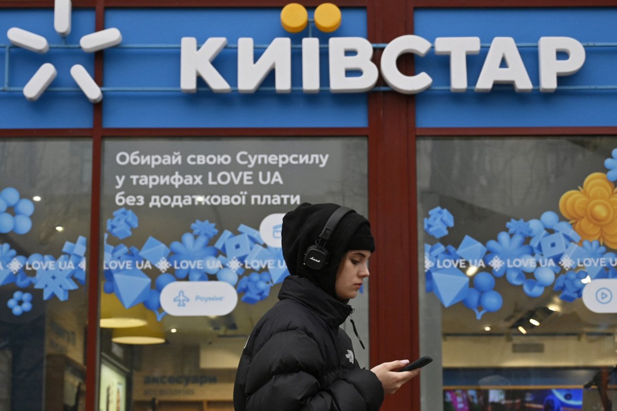 A woman walks by a Kyivstar store