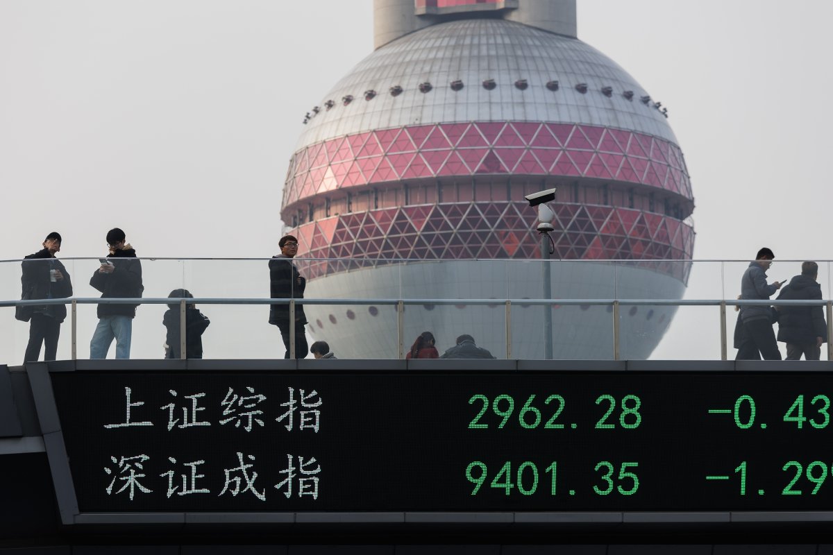 People Cross Shanghai Bridge Displaying Stock Indexes 