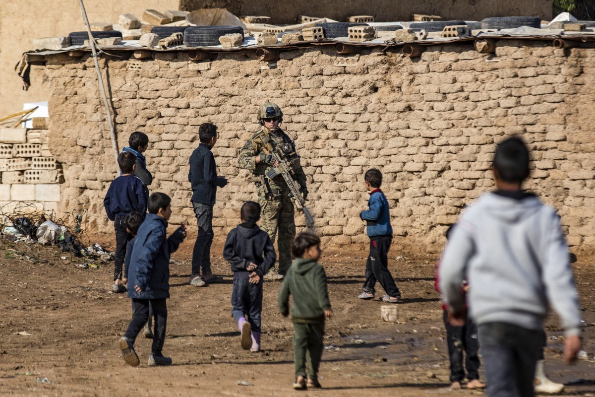 A US soldier is surrounded by children 