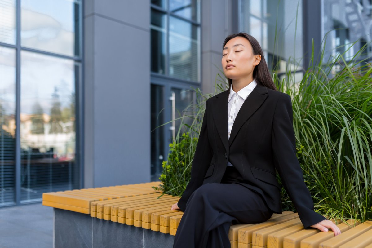 Woman relaxing on outdoor bench.