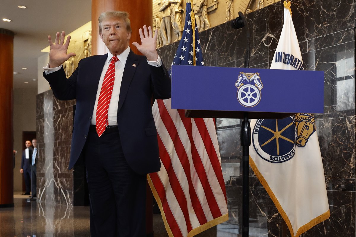 Donald Trump holds up hands