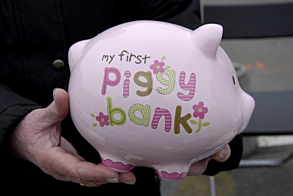 Woman holding children in my first piggy bank 