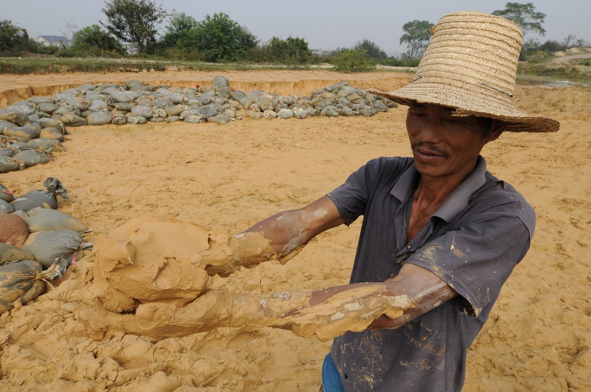 Chinese Worker Holding Rare Earths