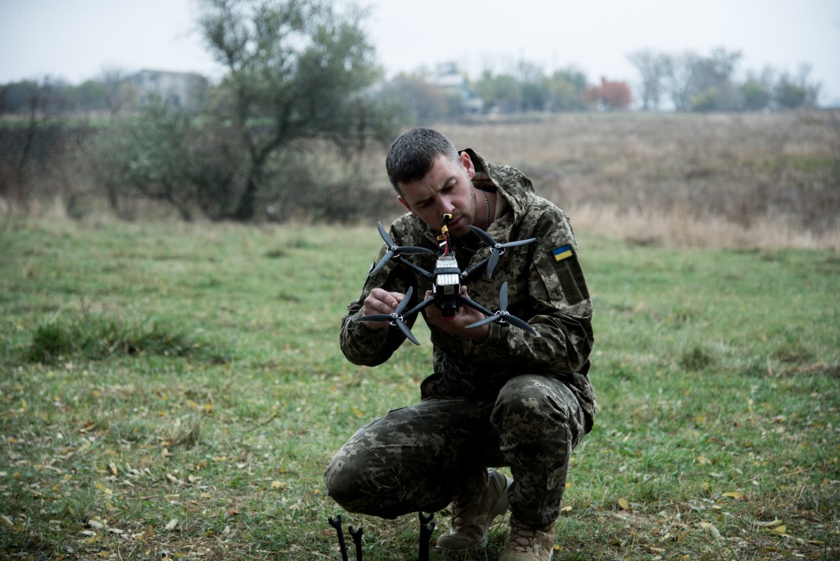 Ukrainian soldier holds a drone 