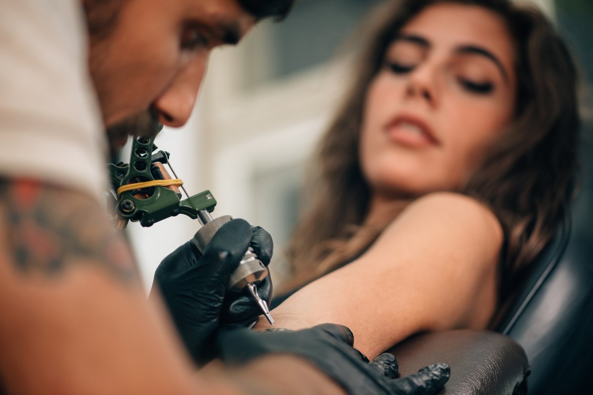 Woman getting tattoo