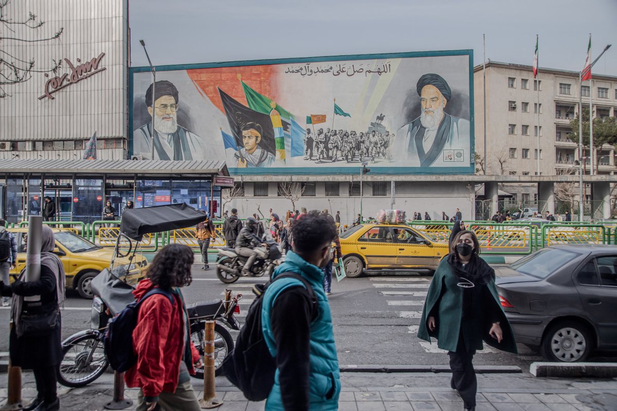Iranian people walk along the streets 