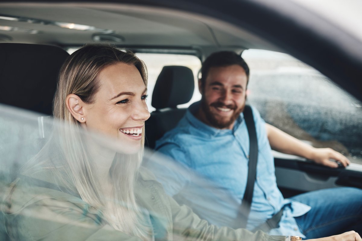 Woman and man in car laughing