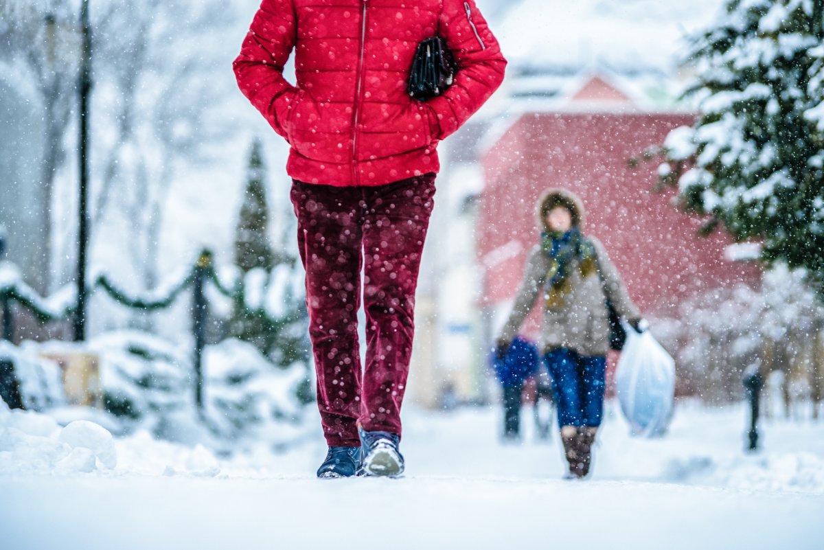 People walking a snowy sidewalk