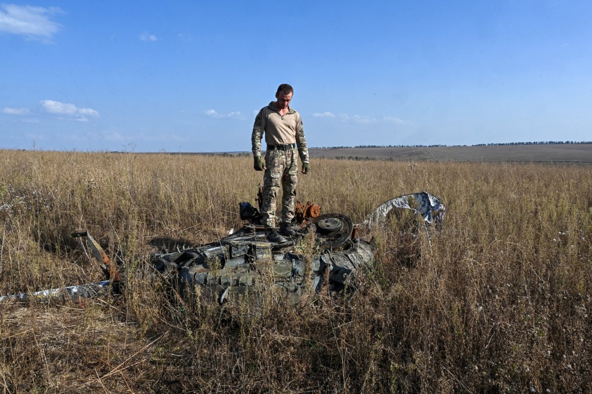 Ukraine volunteer with destroyed Russian tank turret