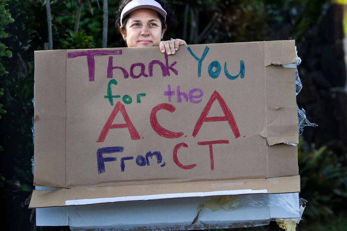 A woman holding a sign 