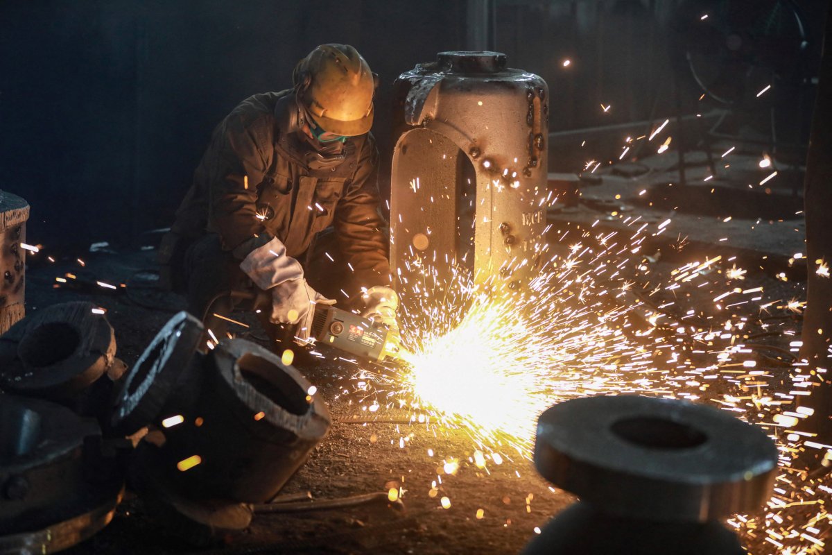 Chinese Factory Employee Works On Steel Casting
