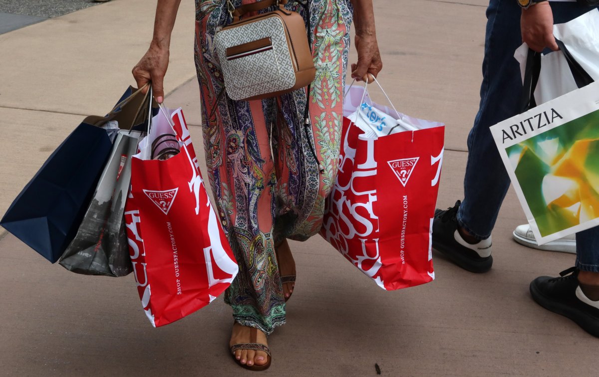 Shoppers carry bags 