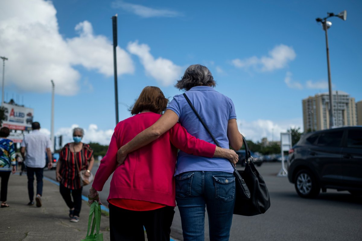 A woman and a senior citizen embrace 