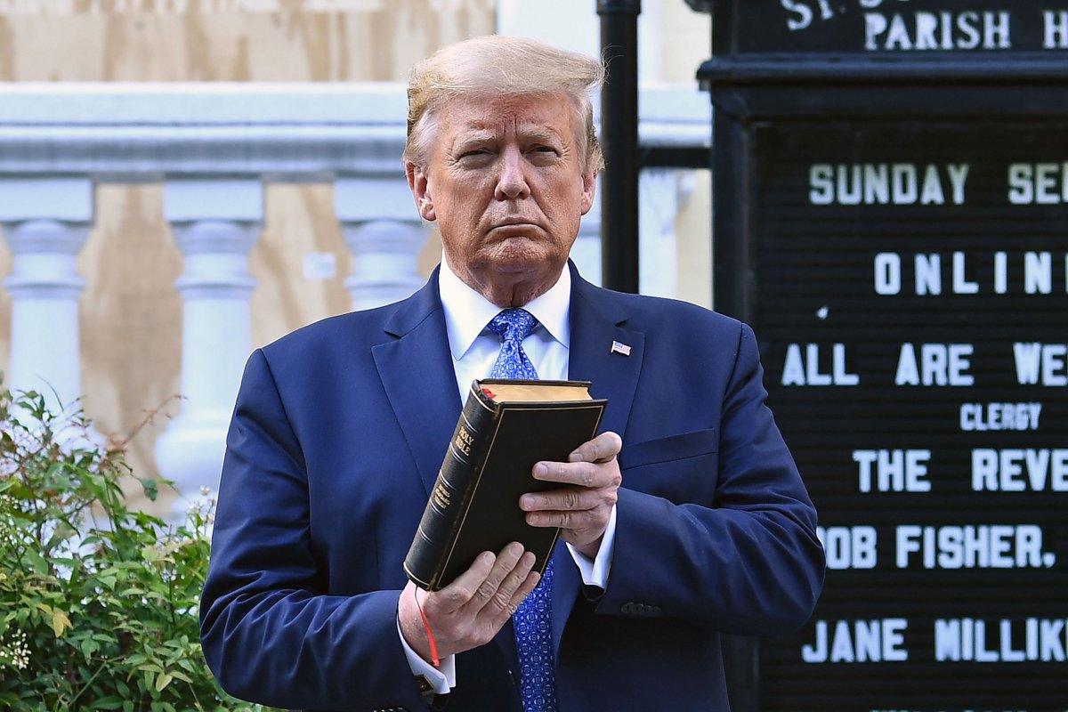 Donald Trump holds up a Bible 