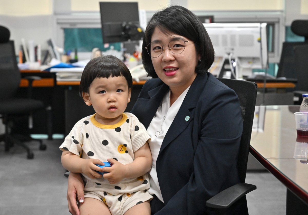 Korean Lawmaker Yong Hye-in Holds Son 