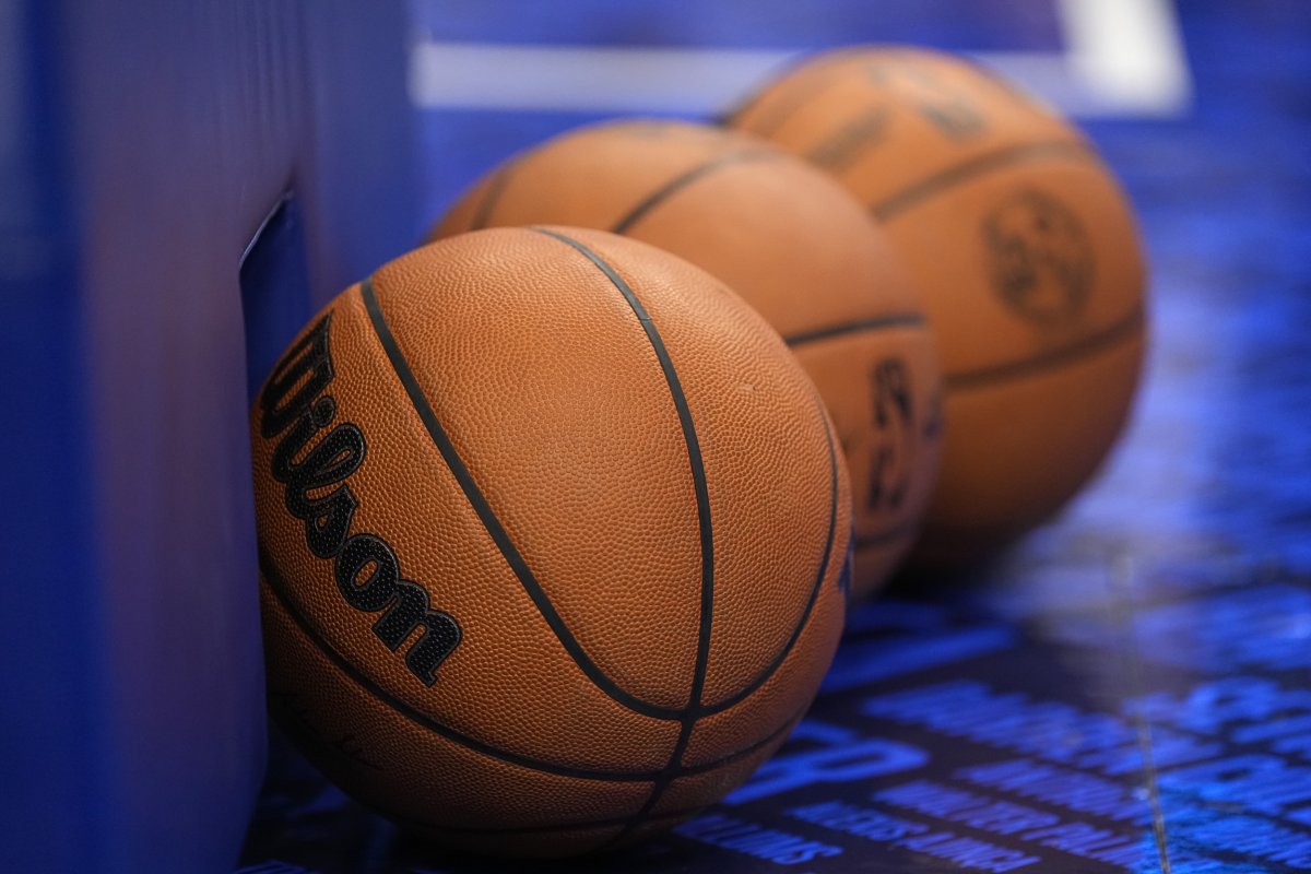 A detail view of basketballs resting 