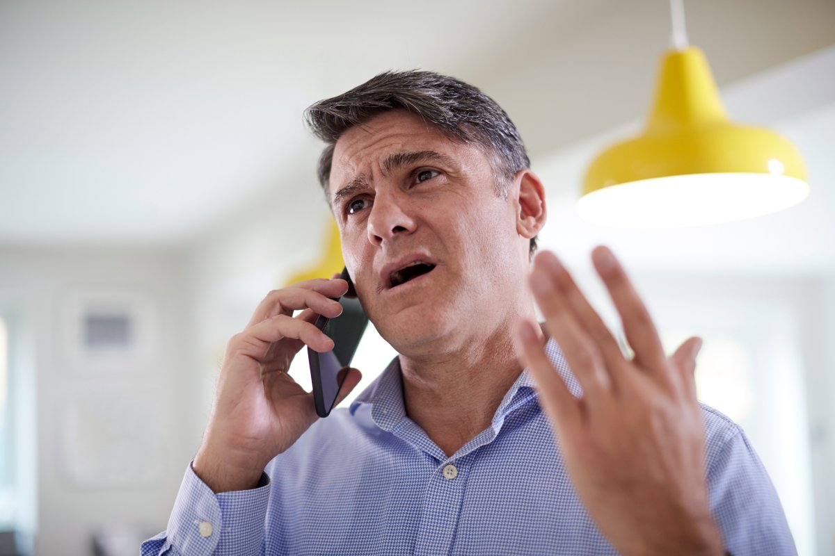 A man appears upset on phone