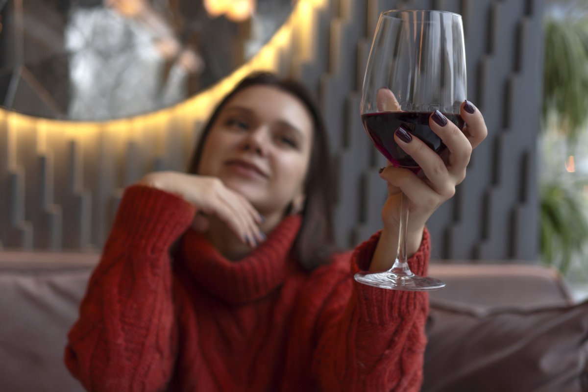 Woman holding red wine 