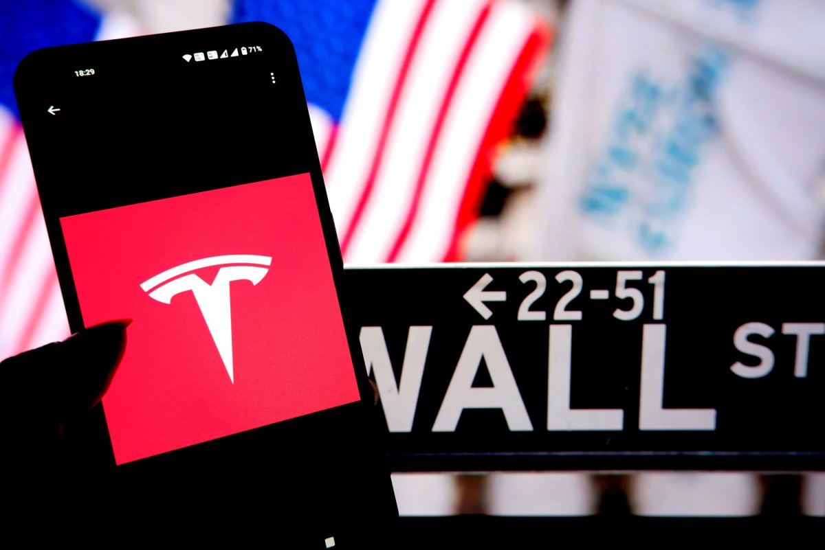 Tesla logo and Wall Street sign