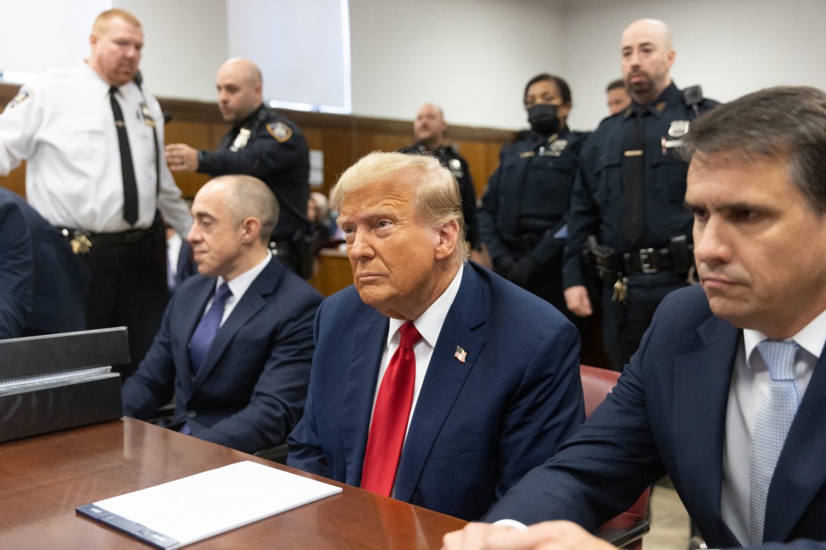 Trump seated in court with lawyers
