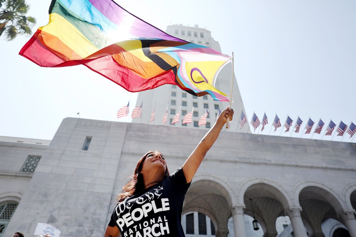 Demonstrator waving pride flag