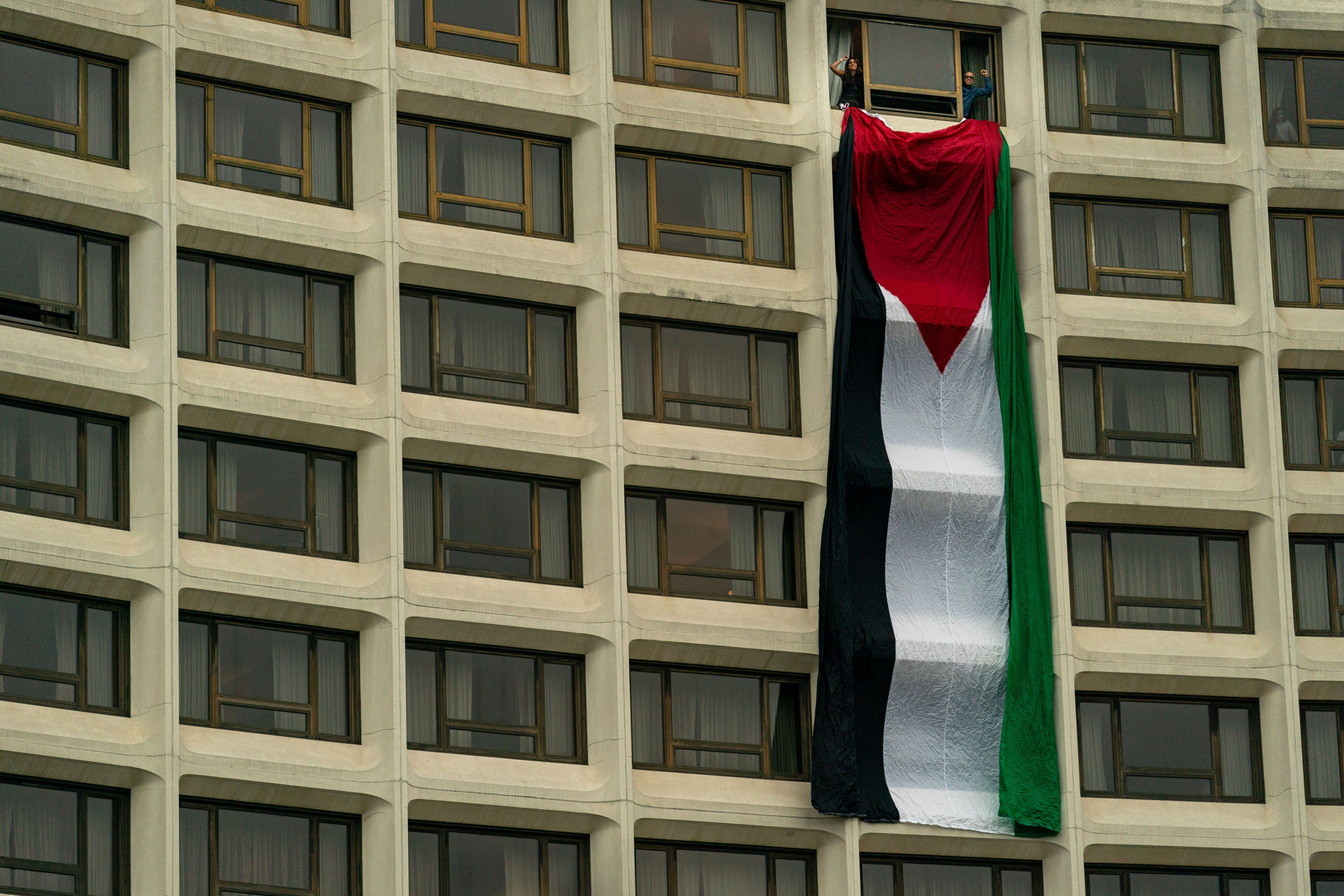 Protesters hang Palestinian flag from venue before Joe Biden’s speech