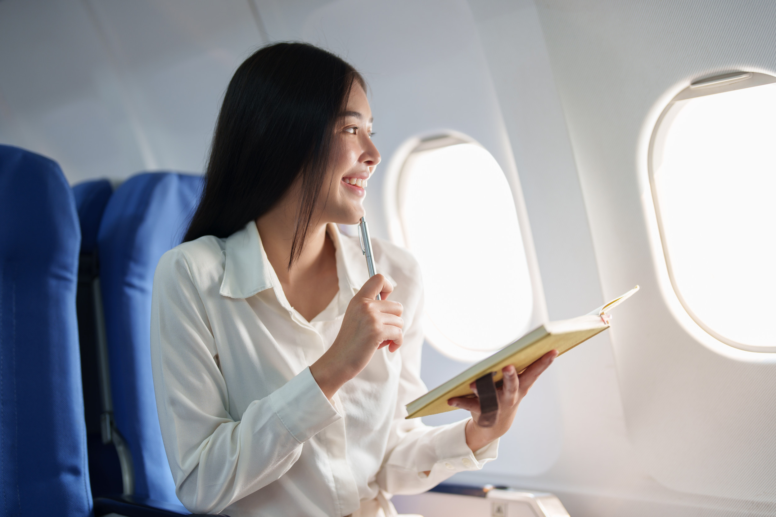 woman-pen-notebook-plane.jpg