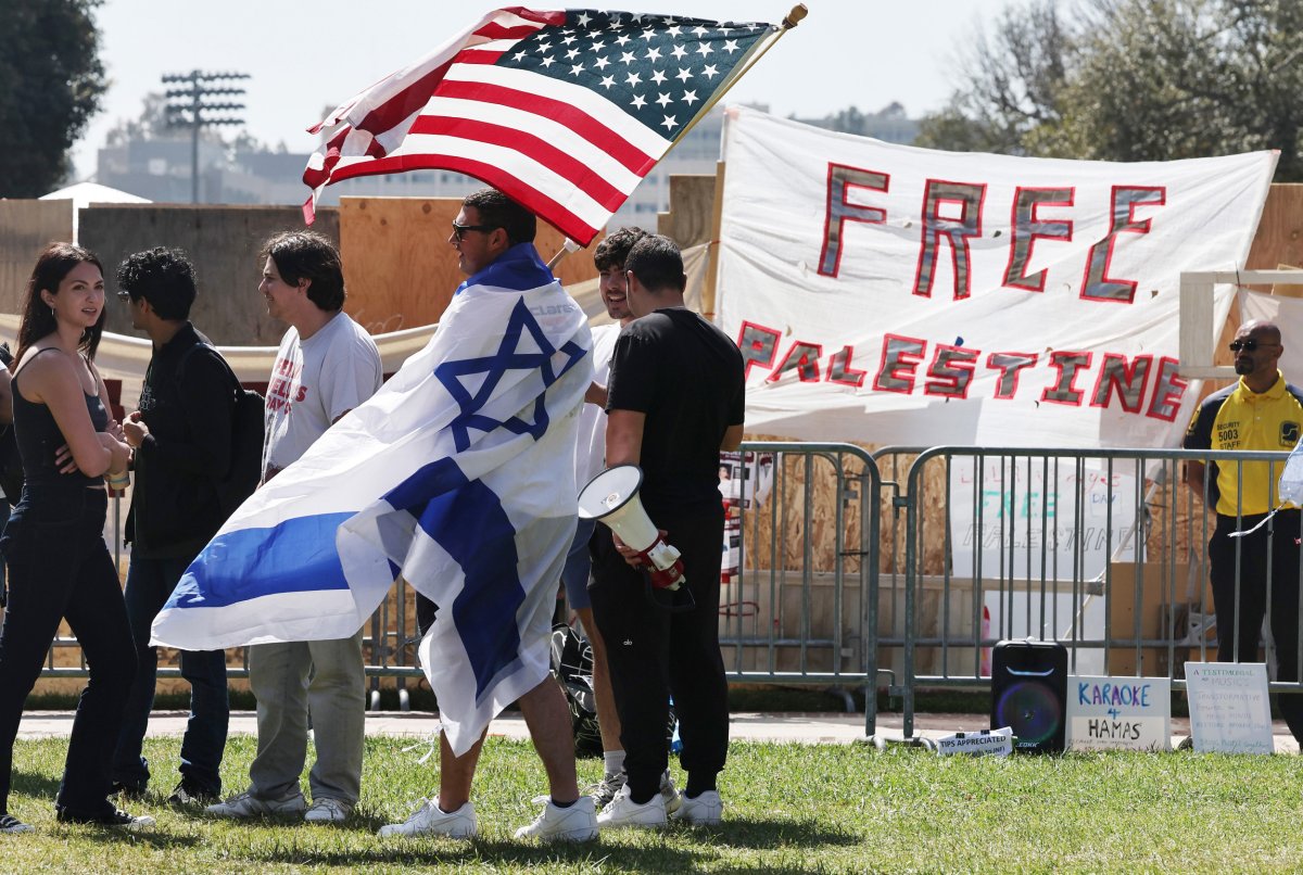 A counter-demonstrator wears an Israeli flag while