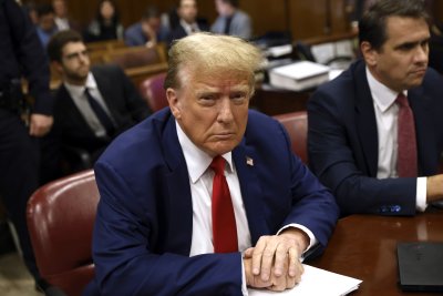 Trump seated at defense table
