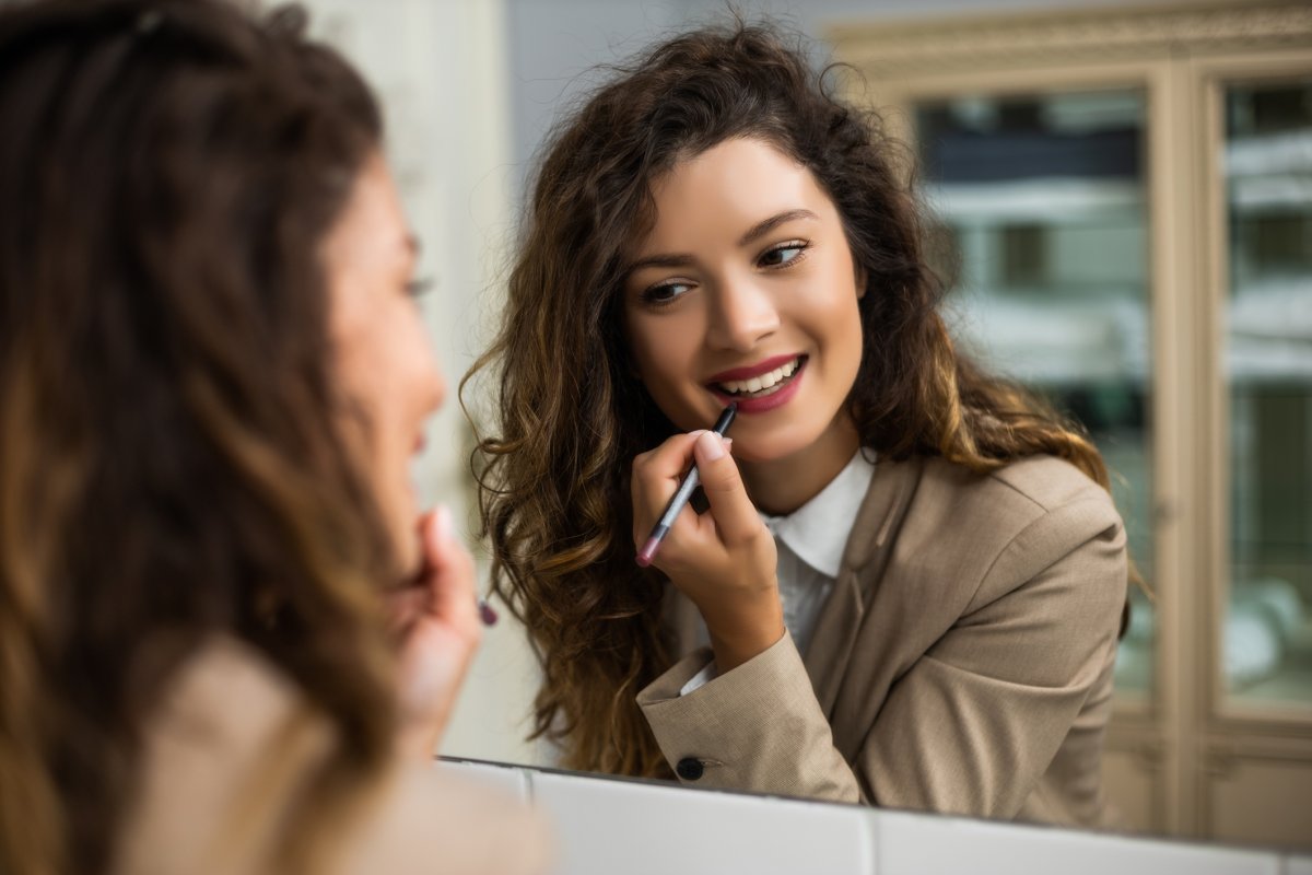 Woman Applying Lipliner in Mirror