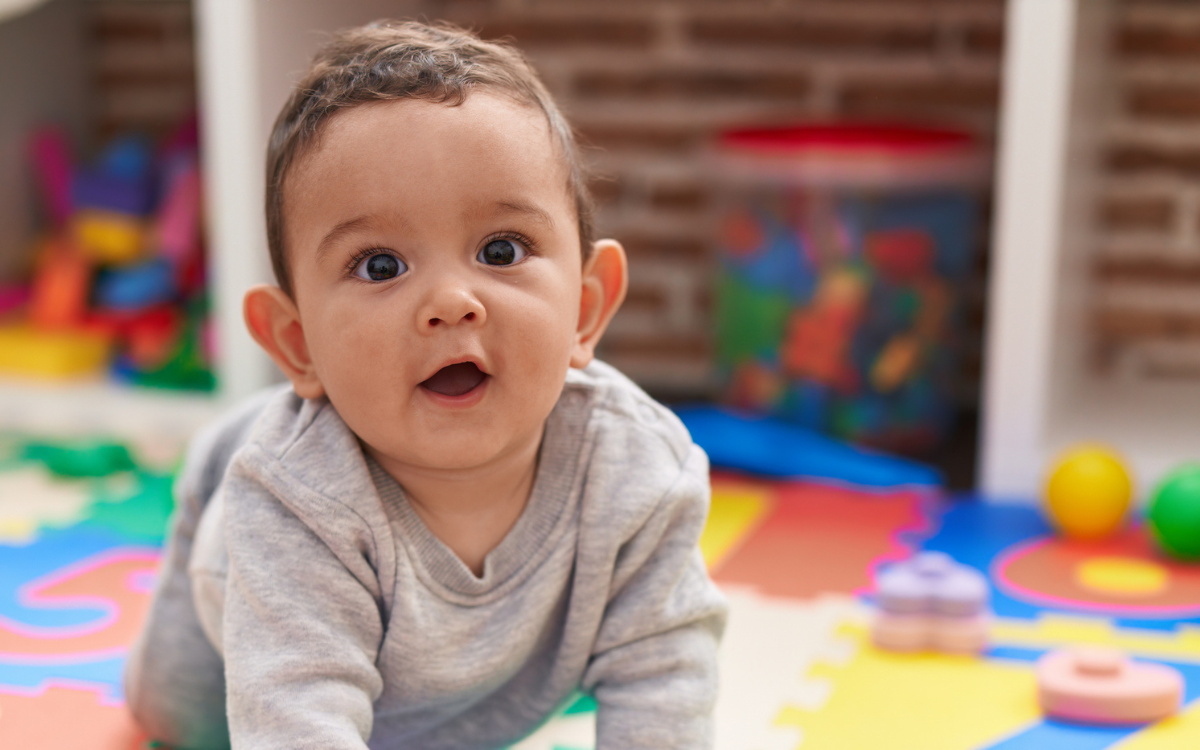 A baby in a play area.