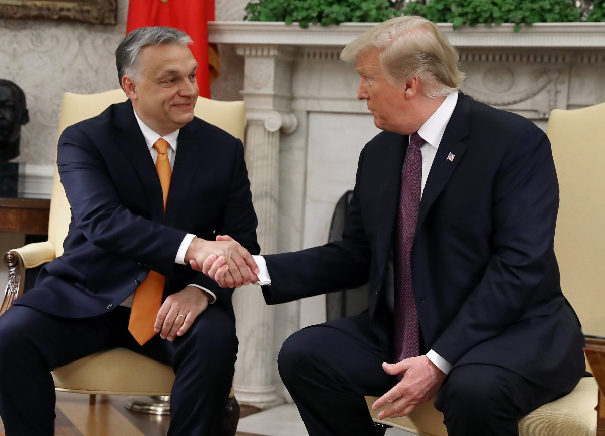 President Donald Trump shakes hands with Orban