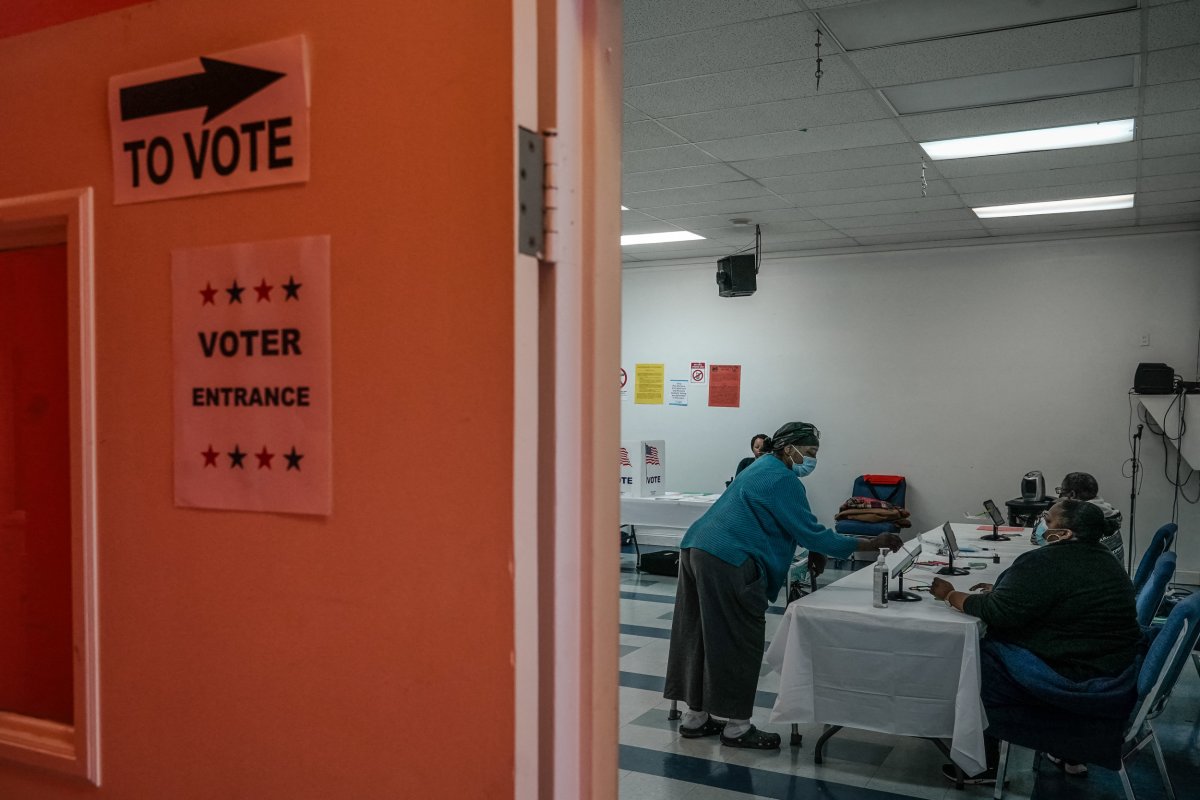 Voter casting ballot.