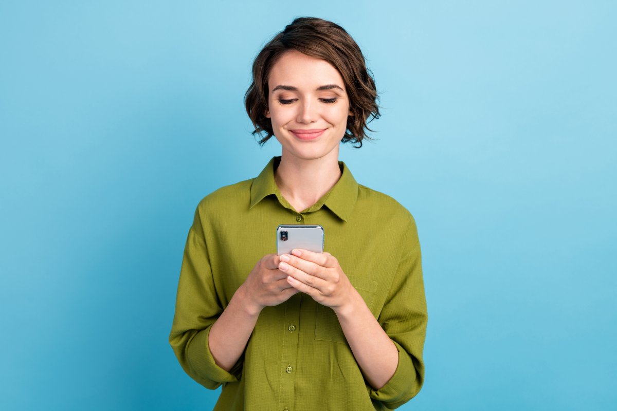 Woman Green Shirt Short Hair Holds Phone