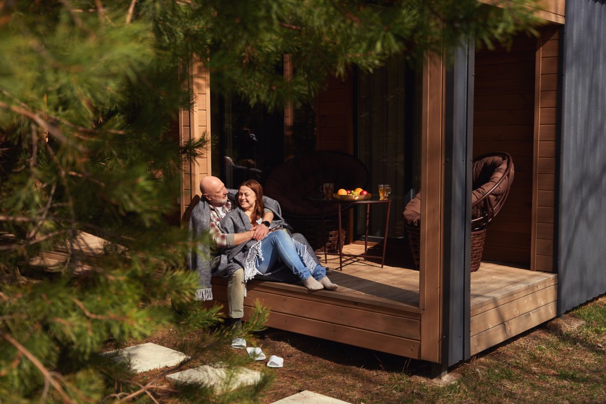 A couple sits on a veranda