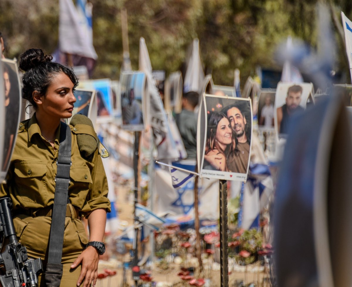 An Israel soldier gazes at a photo 