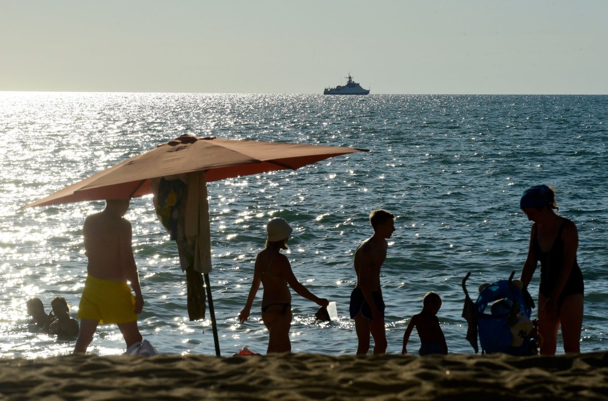 People relax on a beach in Crimea