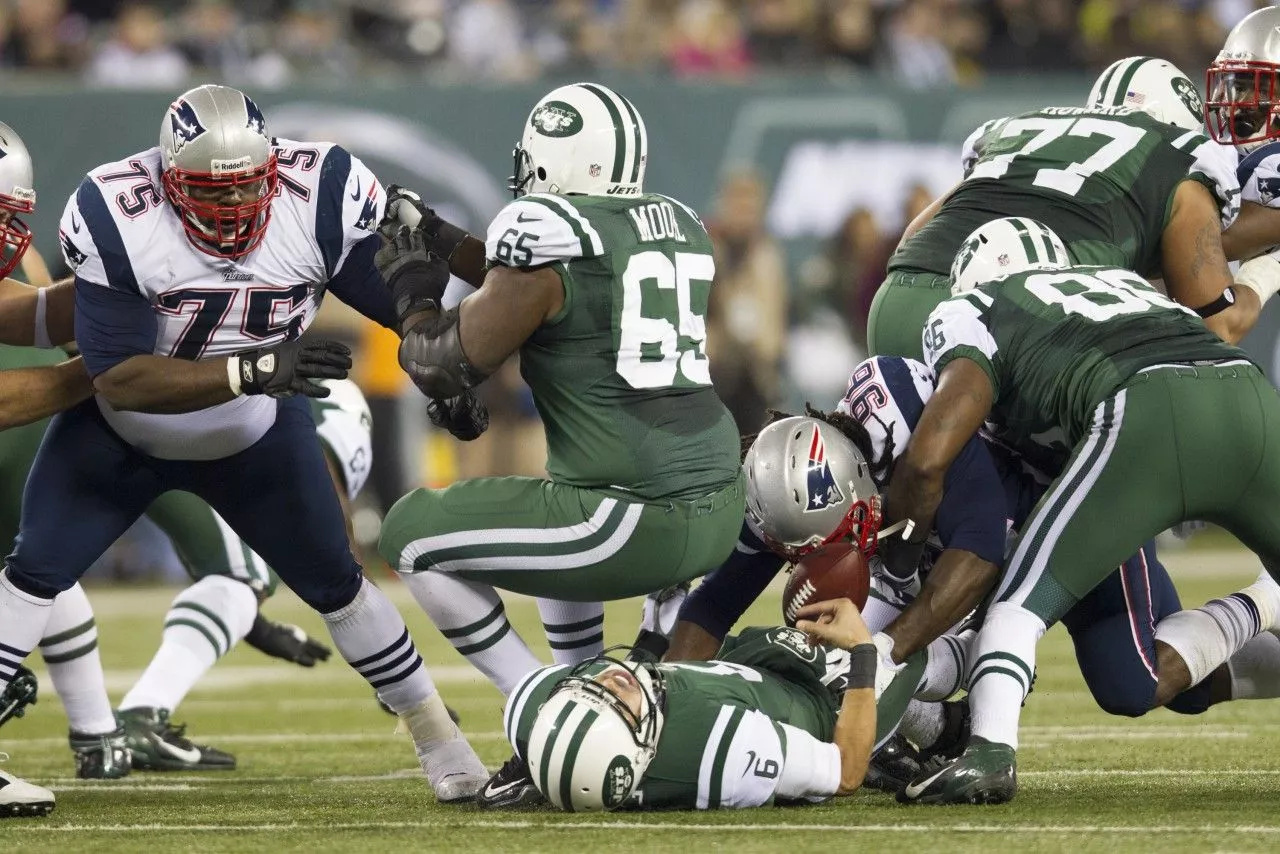 New York Jets Mark Sanchez takes off his helmet after greeting