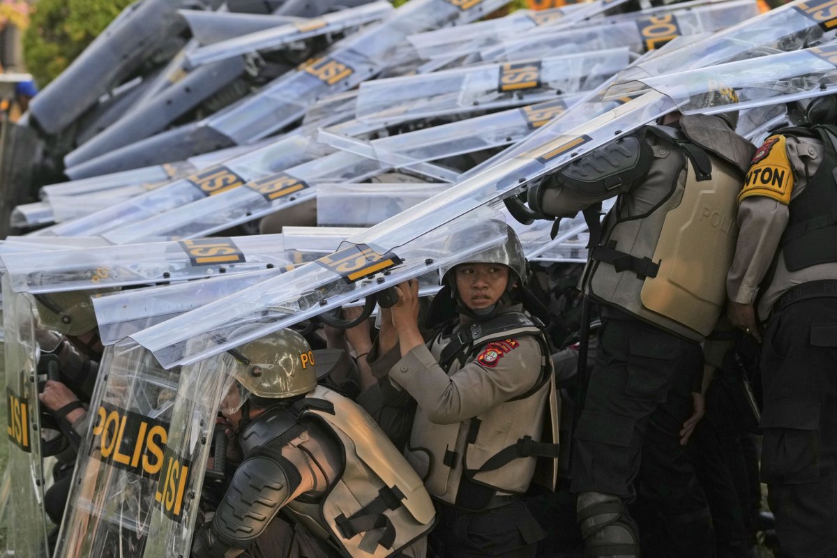Riot police take defensive positions