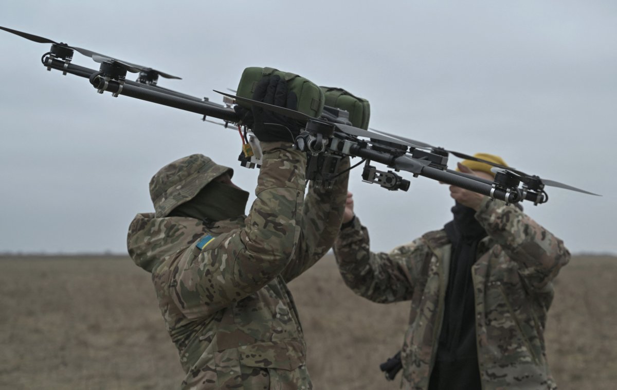Pilots carry a drone in Ukraine