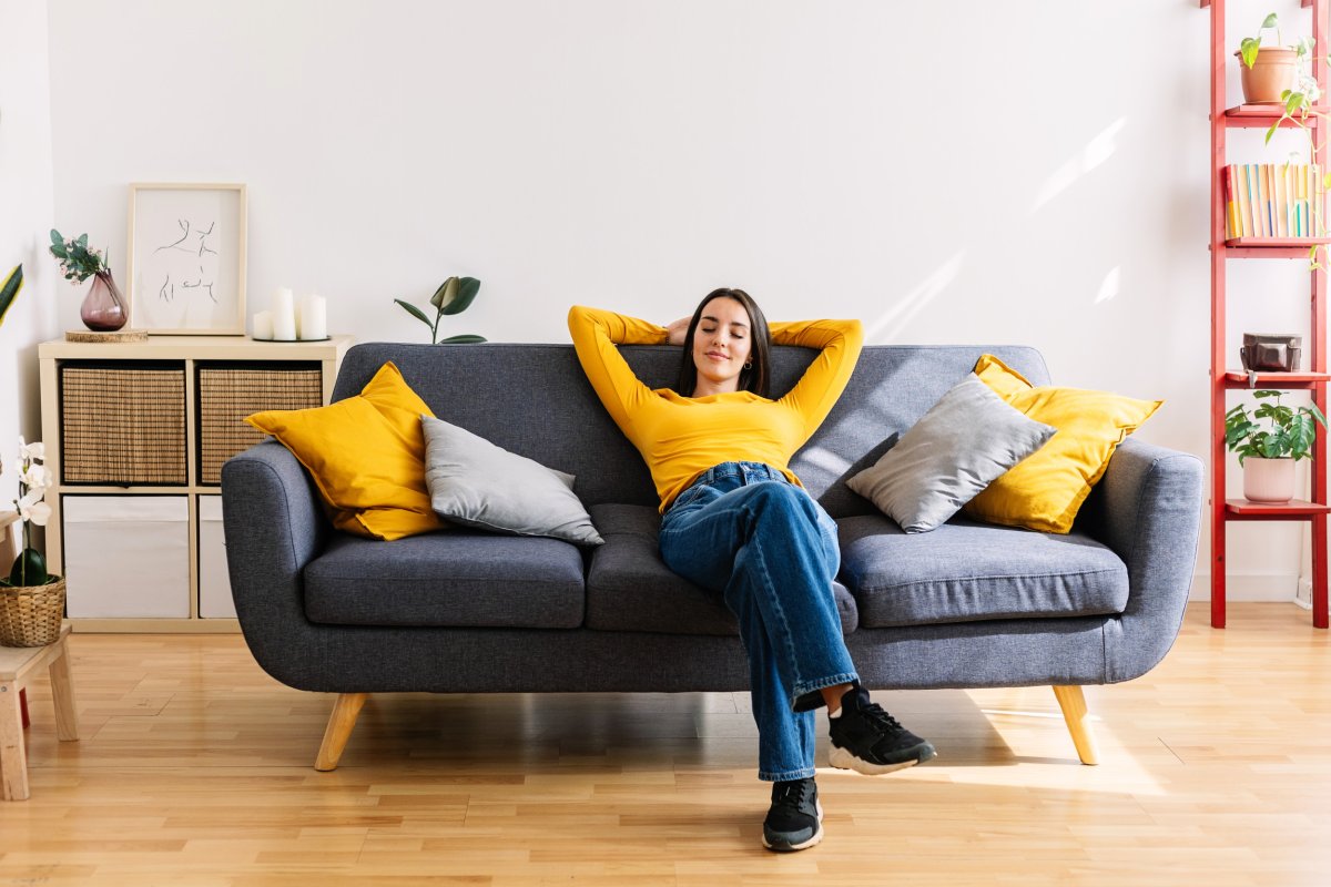 Woman relaxing on sofa at home.