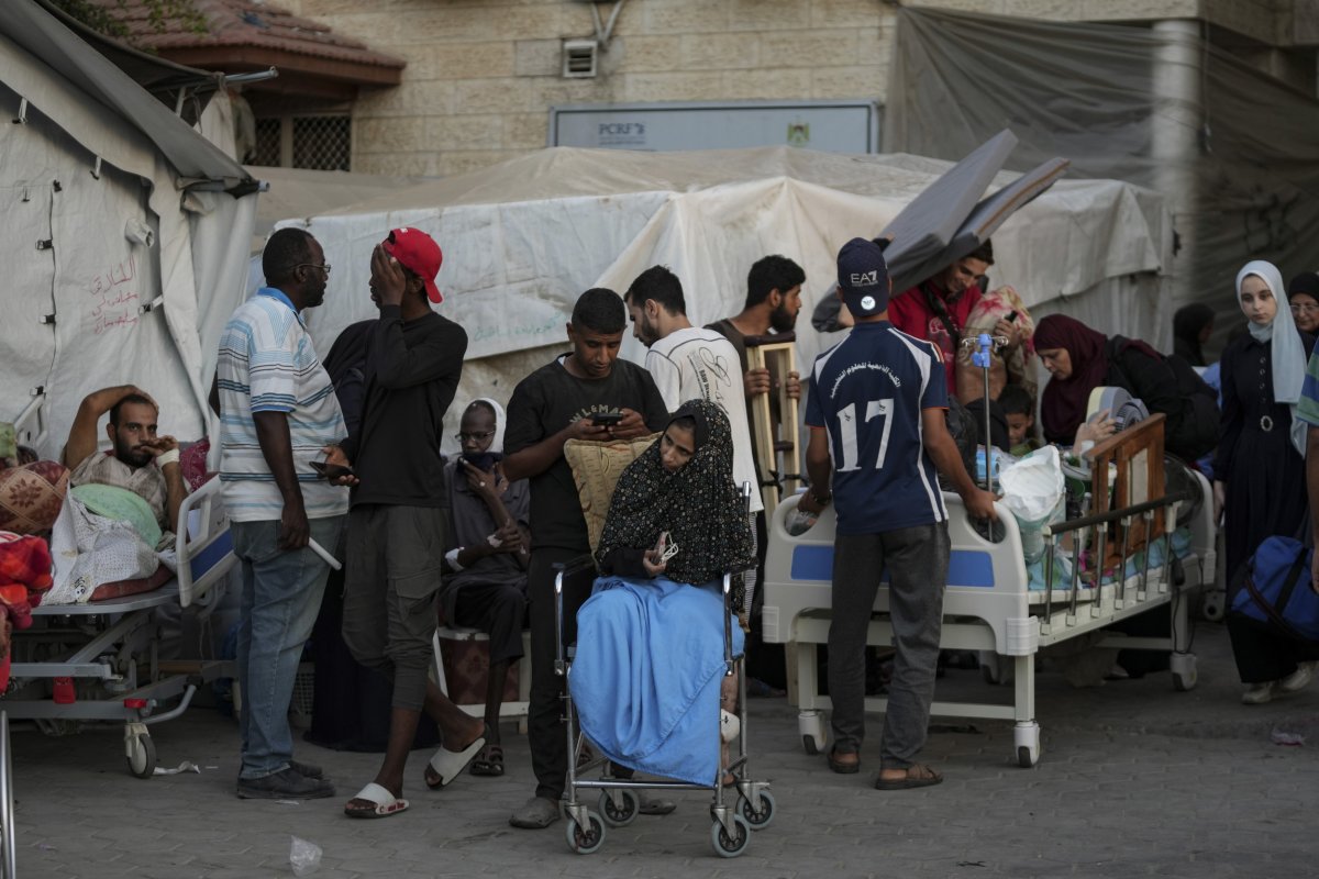 Families outside Al-Aqsa Martyrs hospital