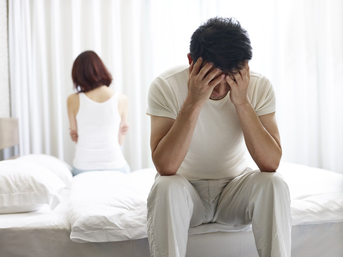 Man Sits On Bed With Woman