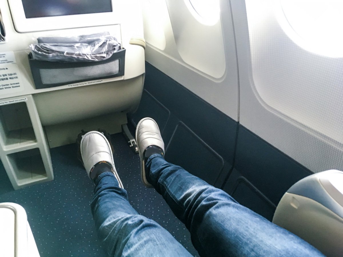 Passenger with legs stretched out on plane.