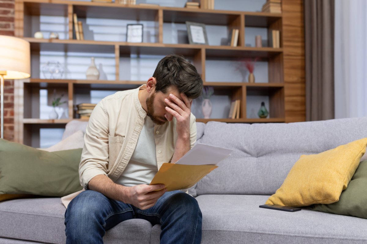 A man reads a letter upset