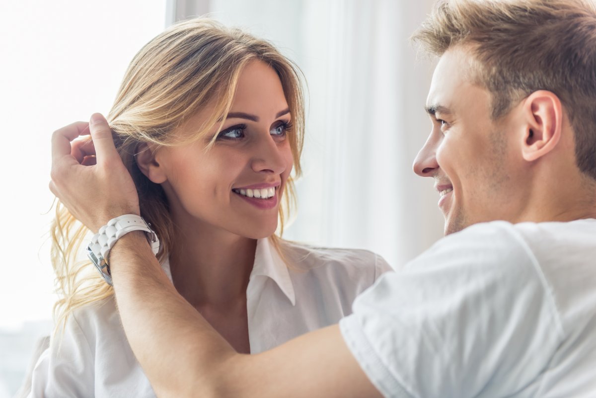 A man looks lovingly at partner's hair
