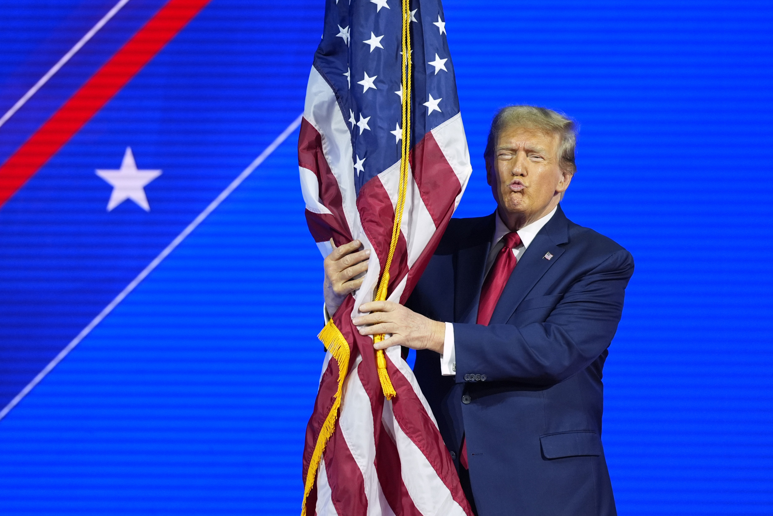 Donald Trump appears to violate the US flag code in a viral clip