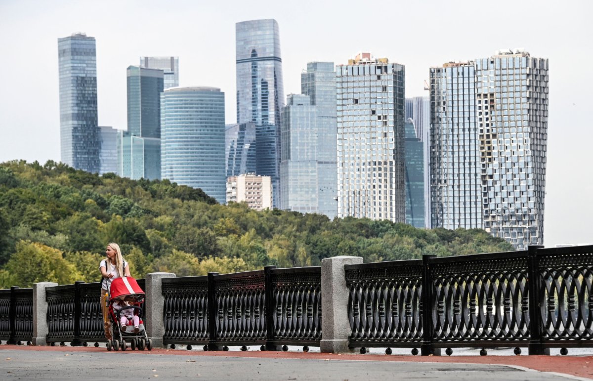 A woman rolls a stroller 